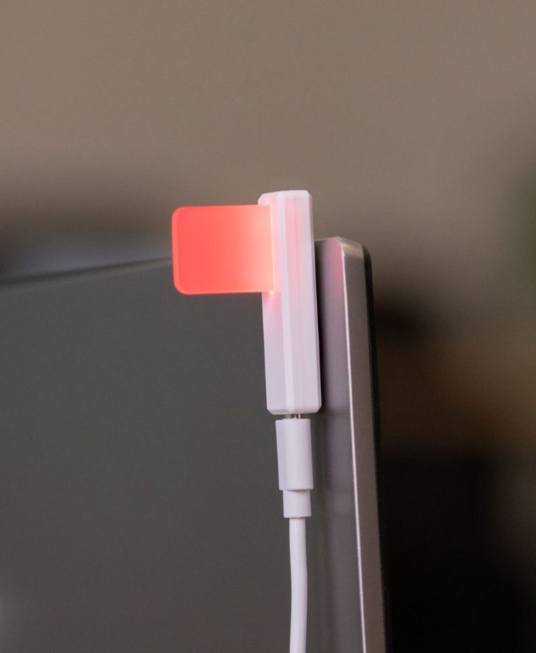 Luxafor Flag 2 glowing red meaning do not disturb attached to a monitor